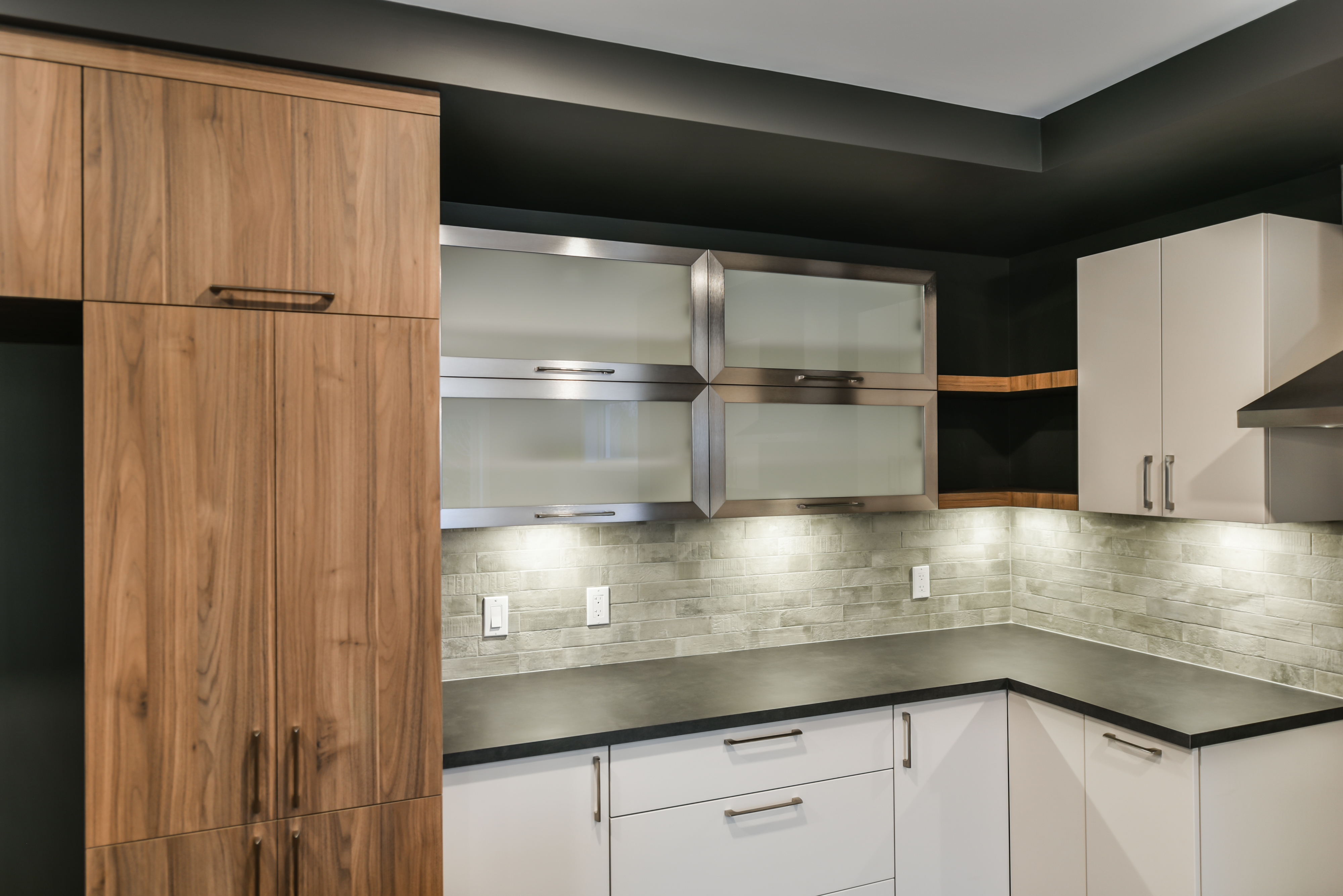 Clean modern kitchen interior with wood and white cabinetry